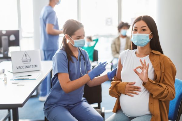Pregnant Asian Lady Gesturing Ok Getting Vaccine Shot